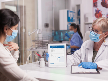 Doctor with face mask looking at tablet 2021 08 29 09 30 31 utc